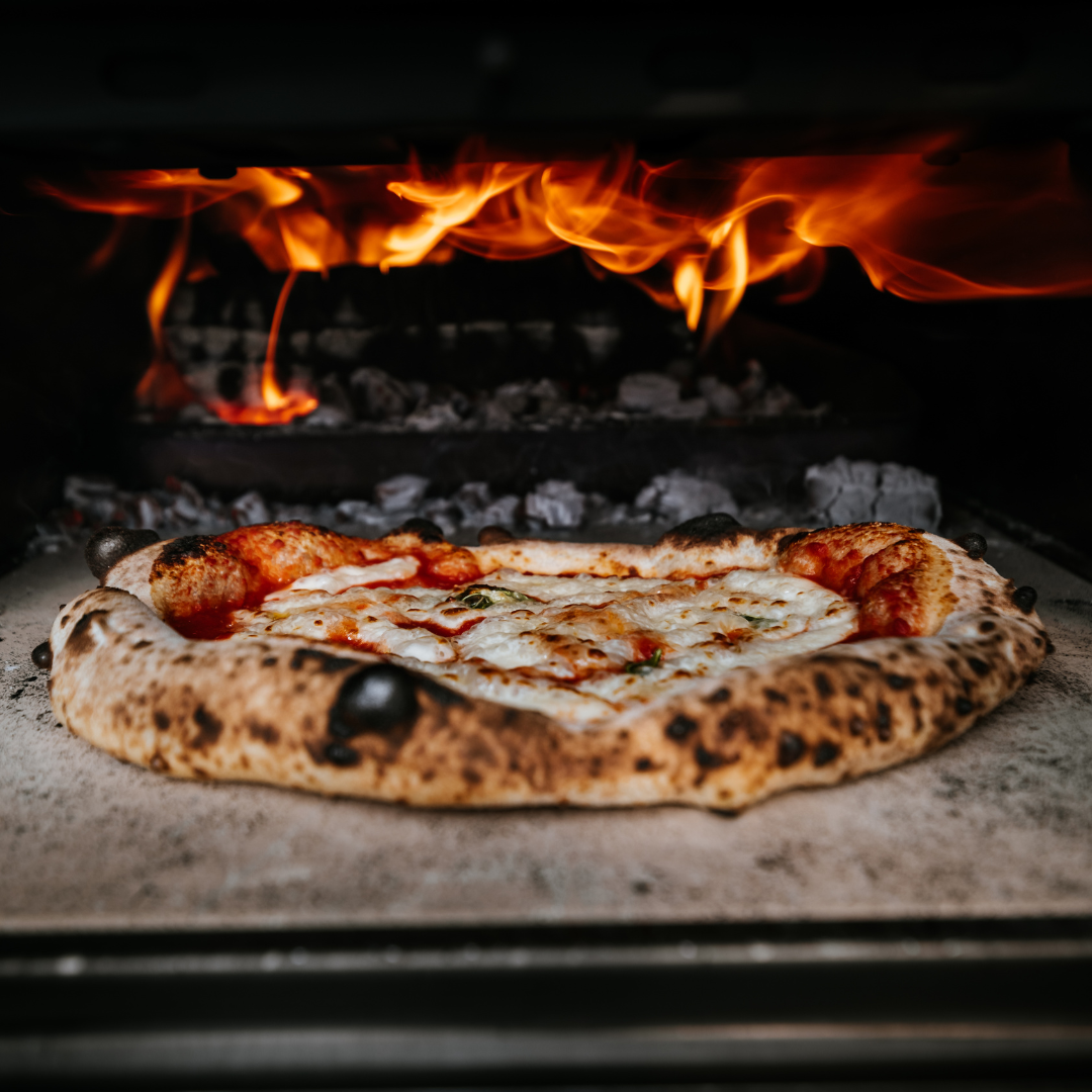 pizza going into an oven