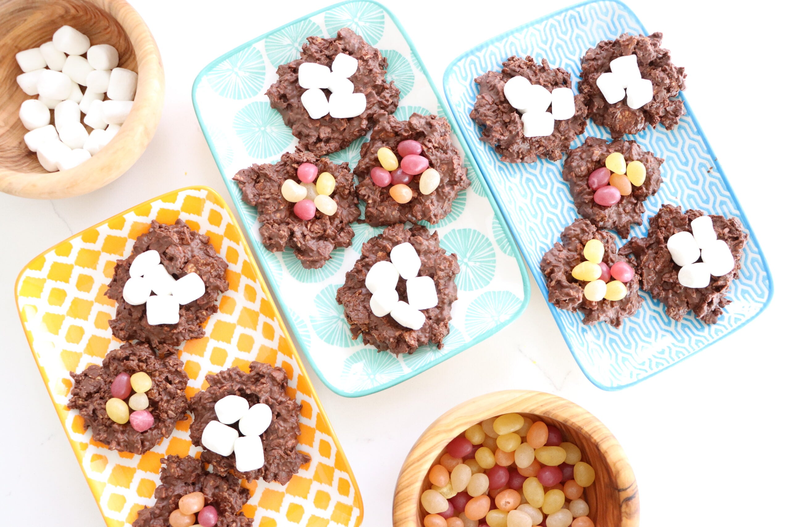 Chocolate Easter Eggs Nests with a bowl of marshmallows and a bowl of jelly beans on a counter