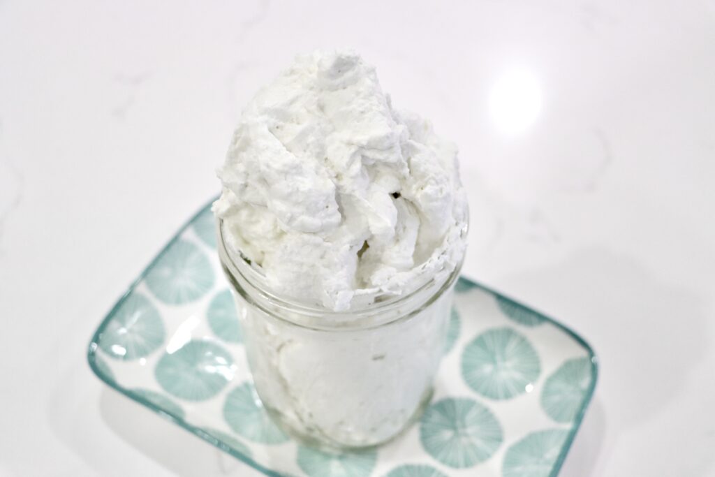 stabilized whipped cream in a jar on a decorative plate