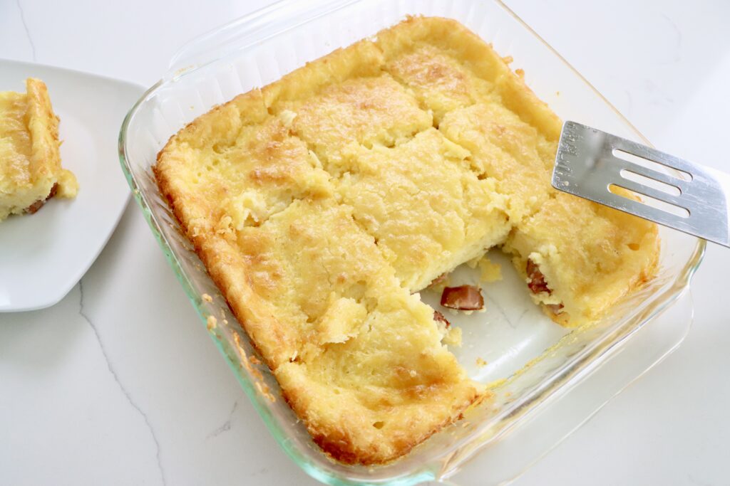 Crustless ham and cheese quiche in a pan and on a small plate