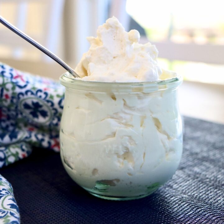 Stabilized Whipped Cream in a glass jar with a colorful towel
