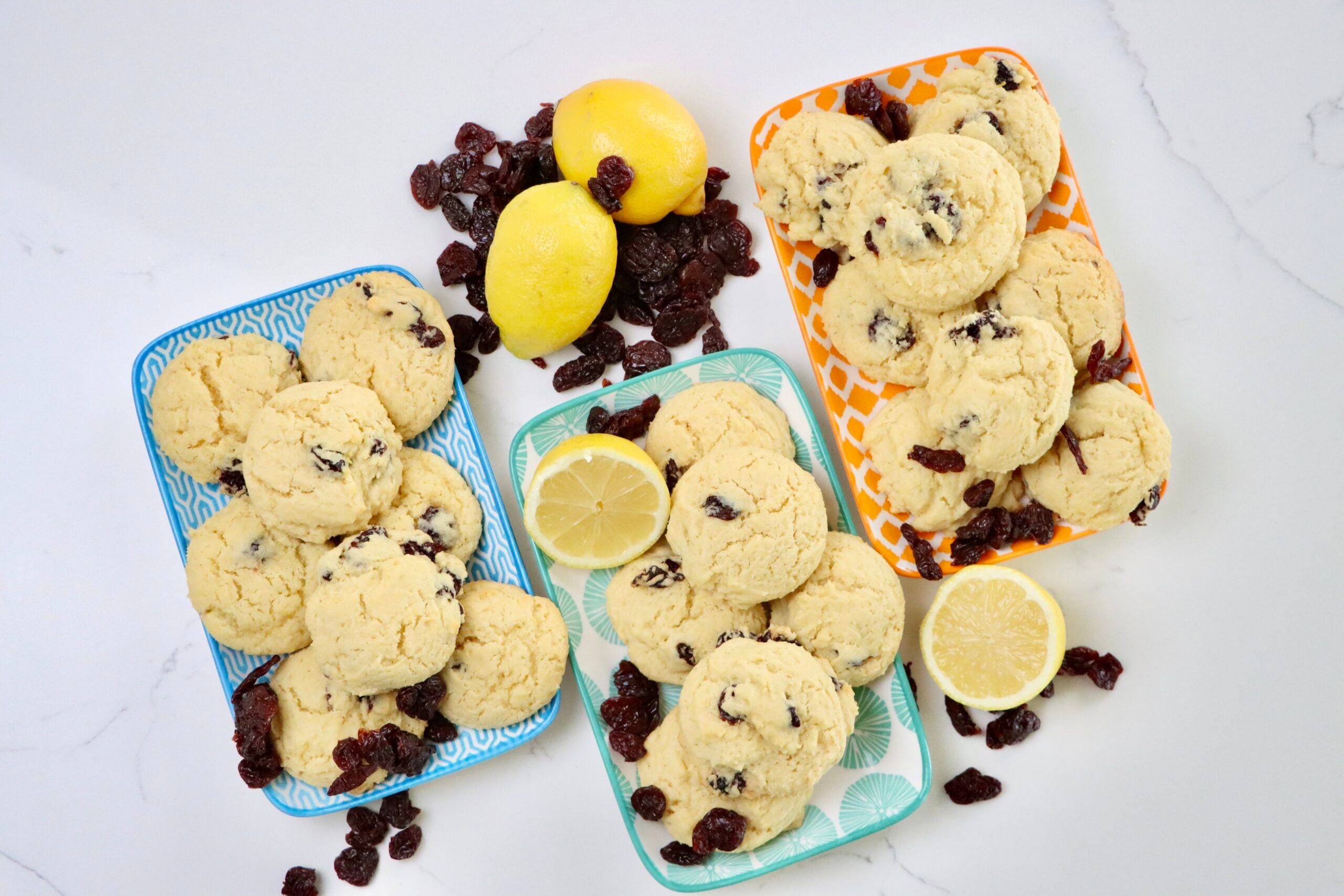 Lemon Cherry Cookies on 3 trays accented with dried cherries and lemons