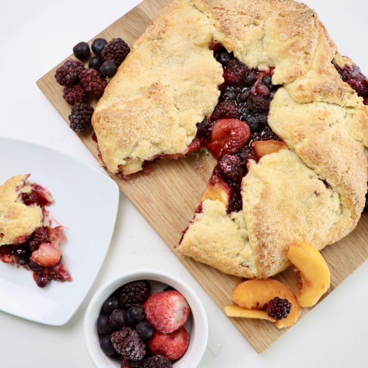 Rustic Berry Peach Galette on a cutting board with fruit