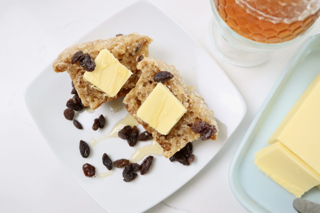 Whole Wheat Yogurt Muffins on a plate with butter and honey on them
