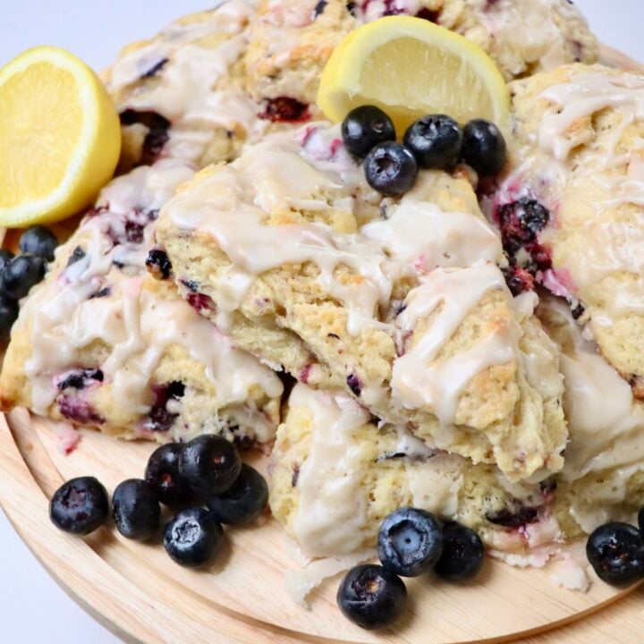 Sourdough Blueberry Lemon Scones on a tray with lemons and blueberries