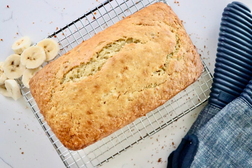 Banana bread cooling on a wire rack, perfect for slicing and serving.