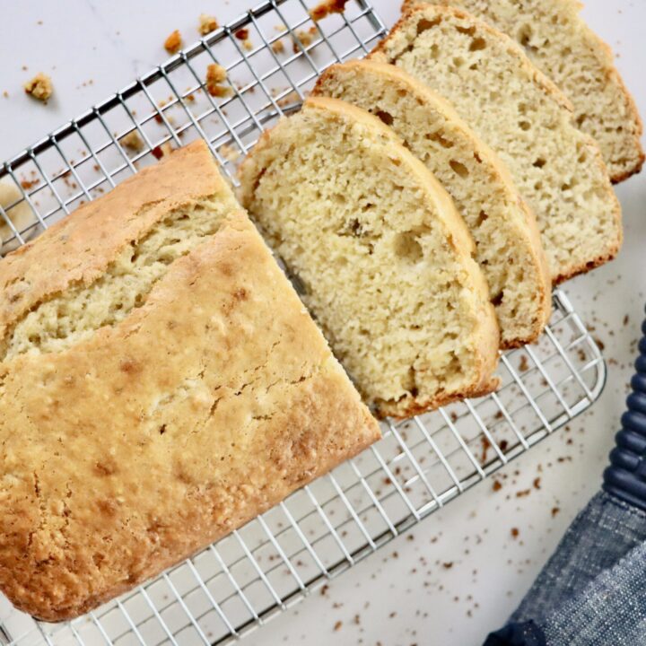 Freshly baked homemade banana bread loaf on a cooling rack, made from scratch with real ingredients.