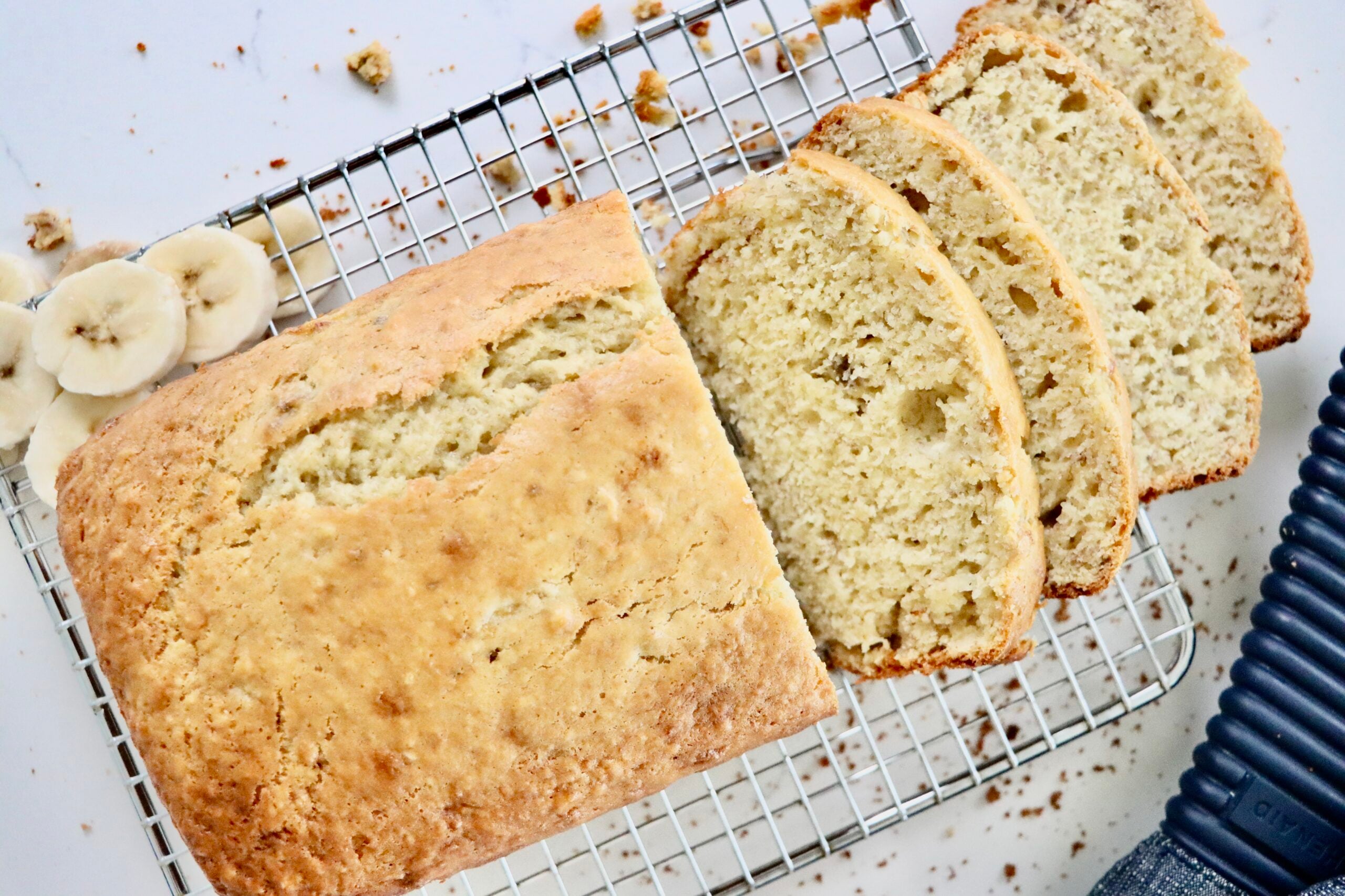 Freshly baked homemade banana bread loaf on a cooling rack, made from scratch with real ingredients.