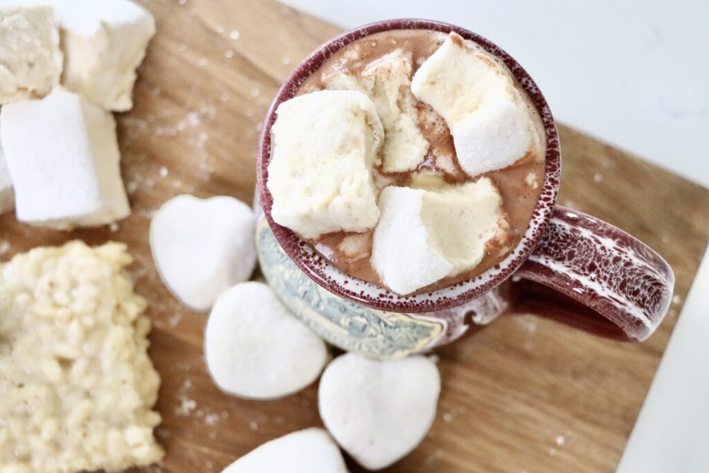 omemade honey maple marshmallows melting into a steaming cup of hot cocoa