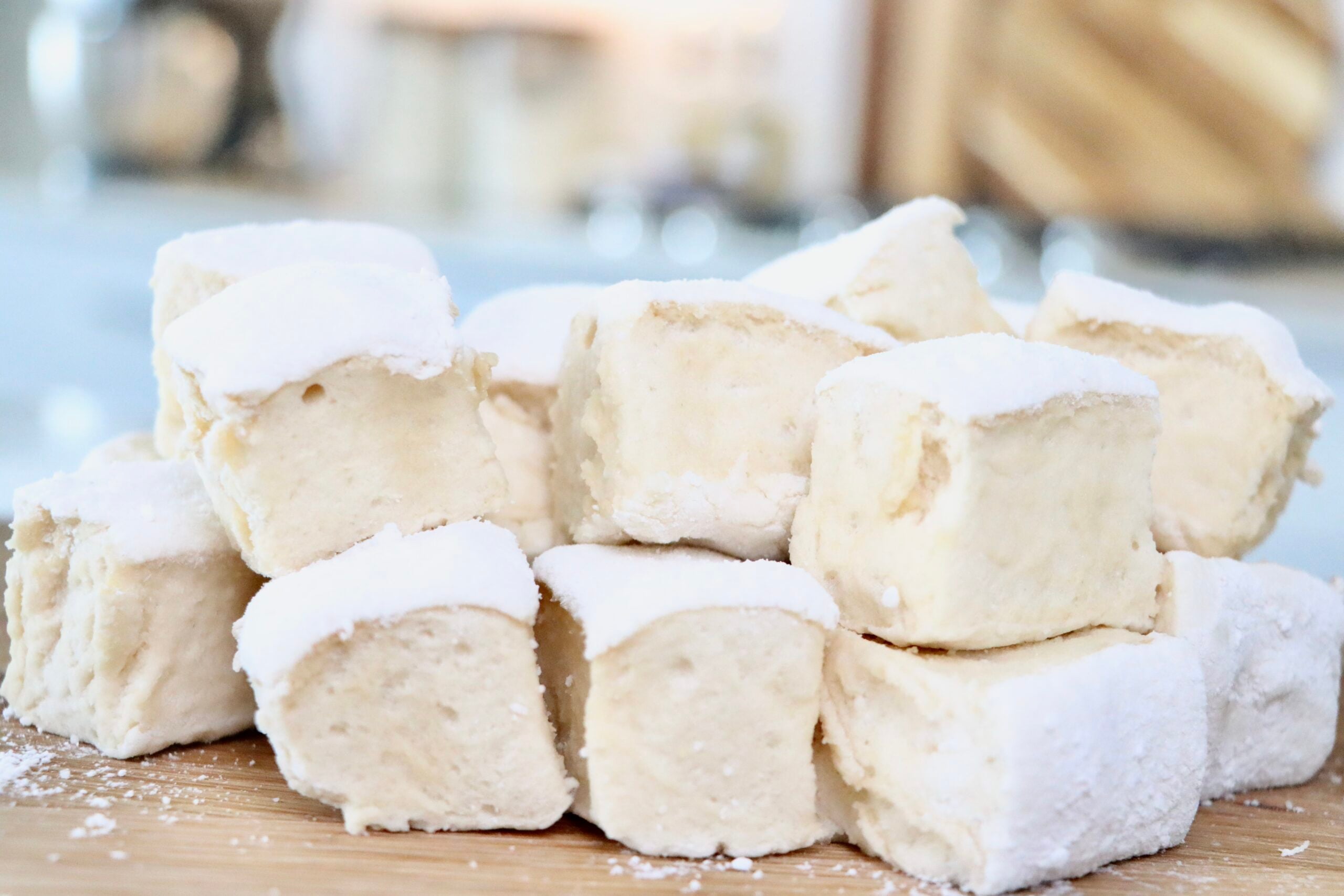 Fluffy homemade honey maple marshmallows cut into large squares, dusted with arrowroot and powdered sugar