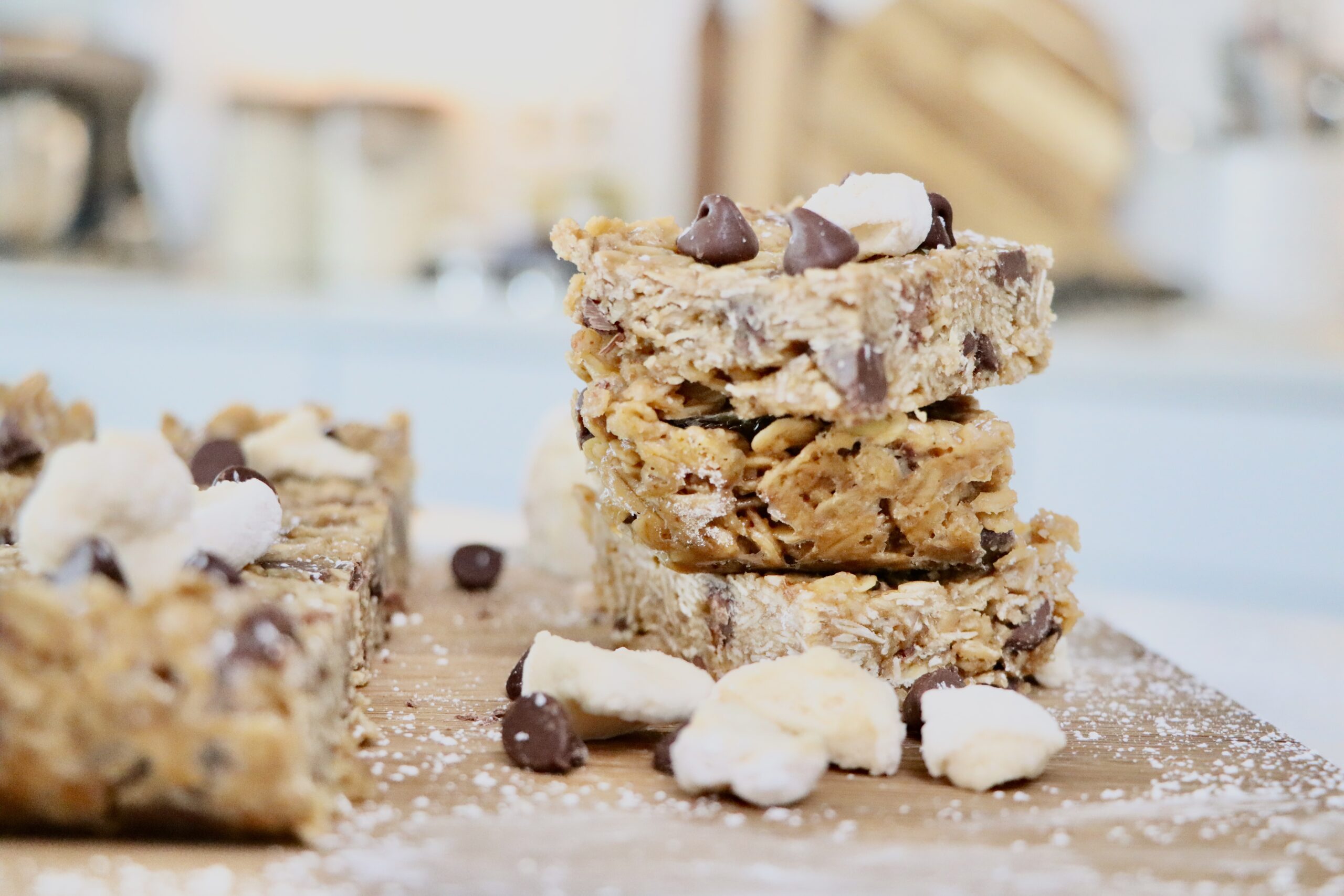 Stack of chewy baked peanut butter granola bars with chocolate chips and homemade marshmallows
