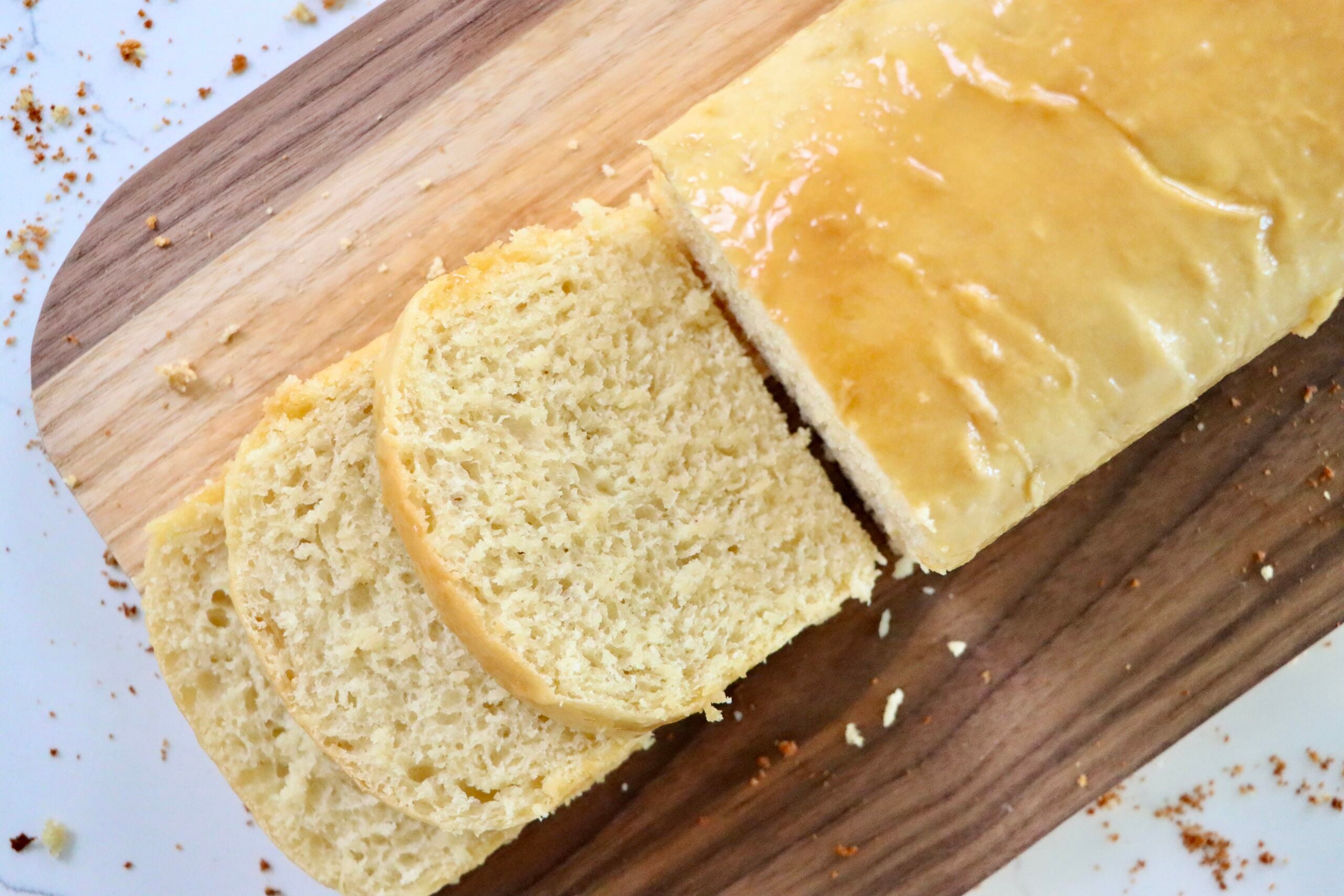 Soft and fluffy slices of sourdough Hawaiian bread showing airy texture and golden crust.