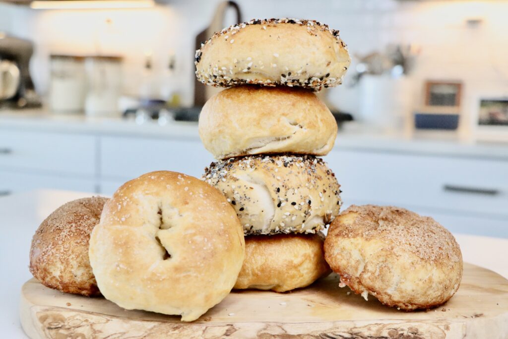 Golden brown homemade sourdough bagels fresh from the oven.