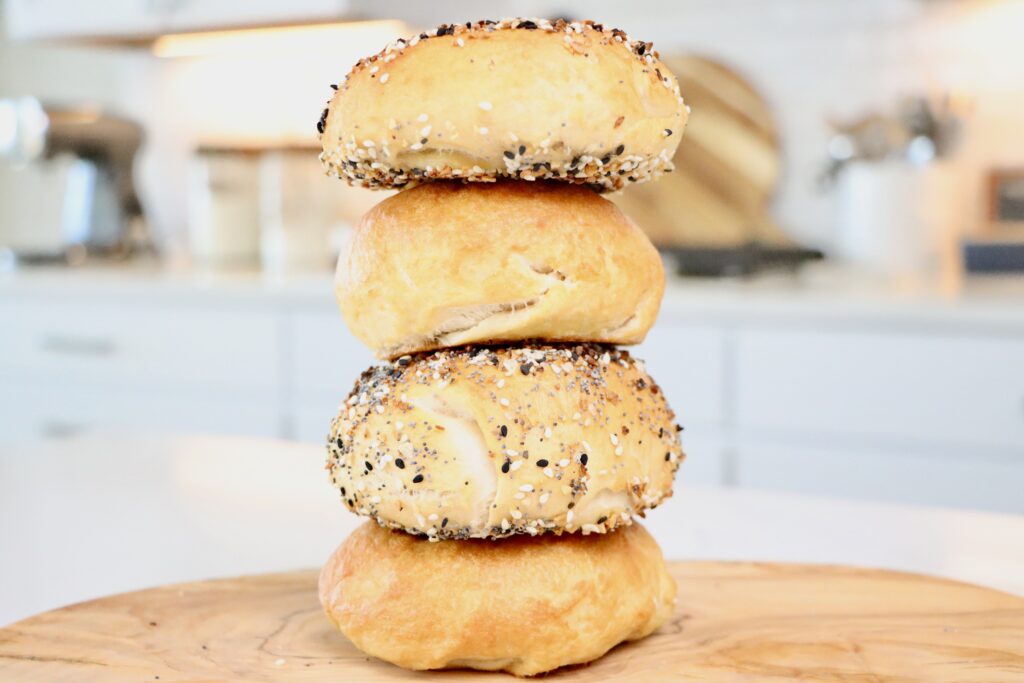 Golden brown homemade sourdough bagels fresh from the oven.