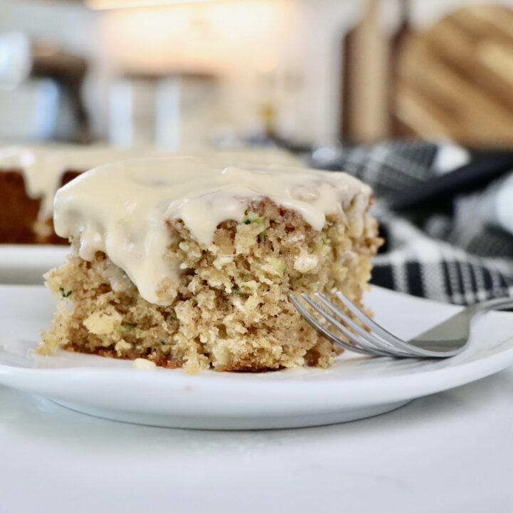 Slice of homemade pineapple zucchini cake showing fluffy texture and golden baked edges, made with whole real ingredients.