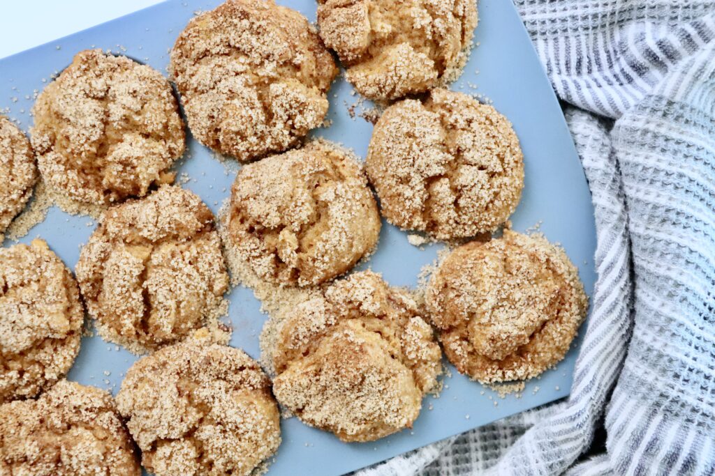 Pumpkin Spice Muffins in a muffin tin next to a tea towel