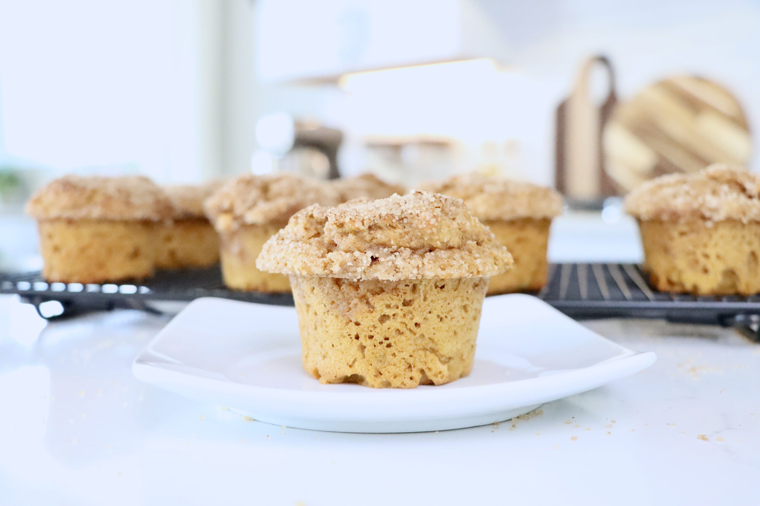 A Pumpkin Spice Muffin on a white plate