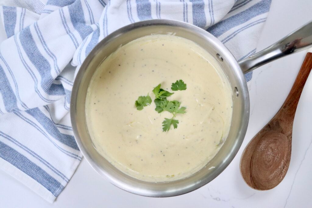 Easy homemade Alfredo sauce from scratch in a saucepan, thick and creamy, perfect for pasta, chicken, or shrimp dishes.