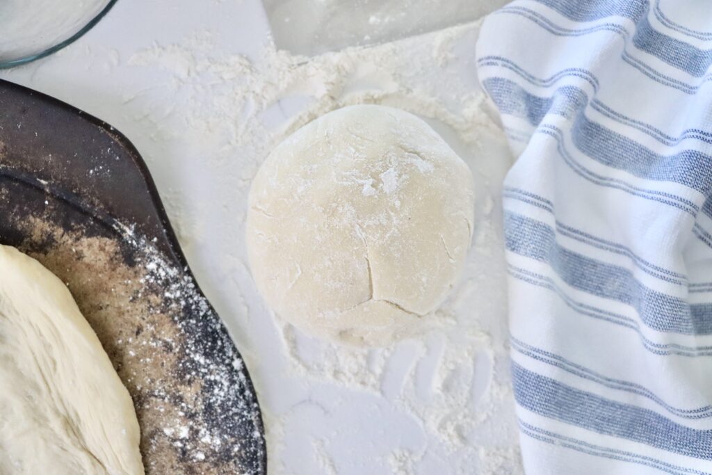 Fermented sourdough pizza dough resting and then shaped into homemade pizza crust