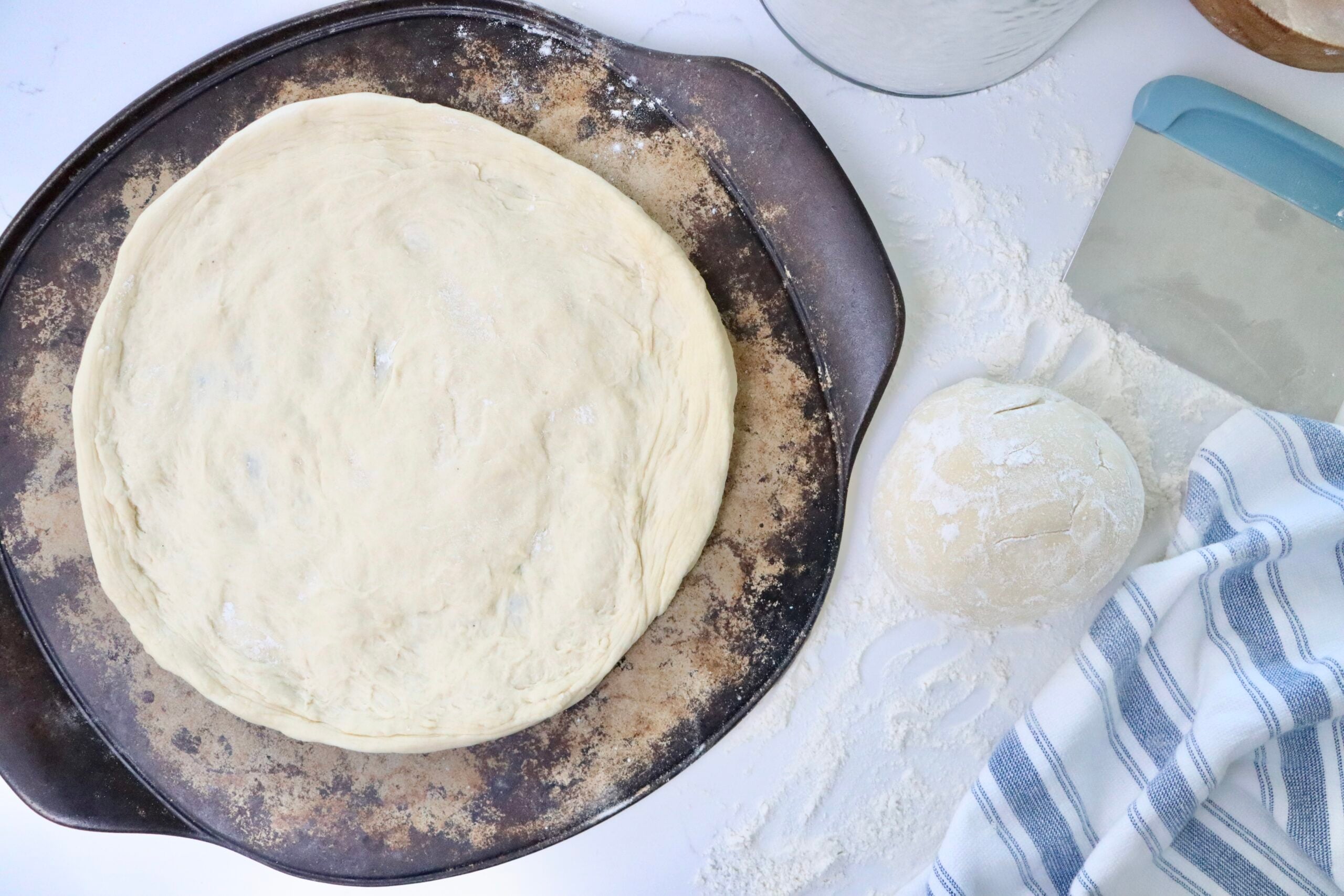 Fermented sourdough pizza dough resting and then shaped into homemade pizza crust