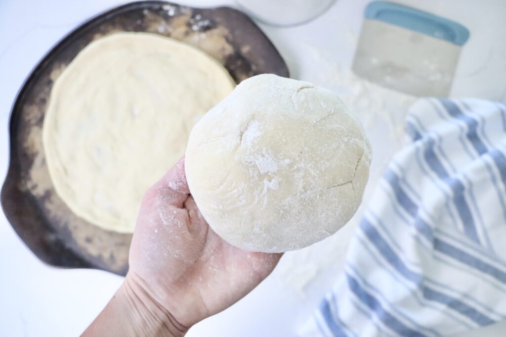 Fermented sourdough pizza dough resting and then shaped into homemade pizza crust