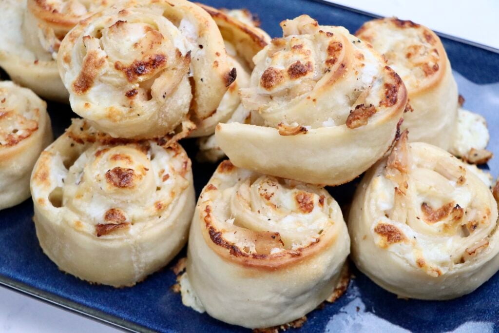Golden sourdough chicken alfredo pizza rolls with melted mozzarella and parmesan cheese, baked to perfection.