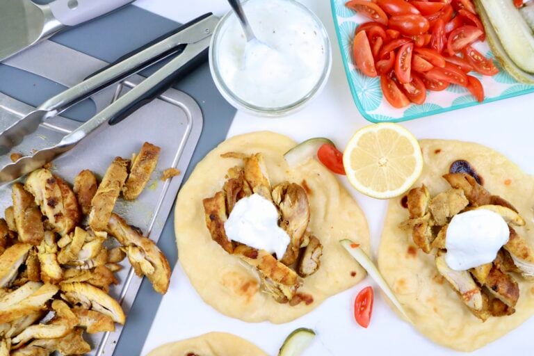 Juicy chicken shawarma sliced and served in warm naan bread with creamy garlic yogurt sauce.