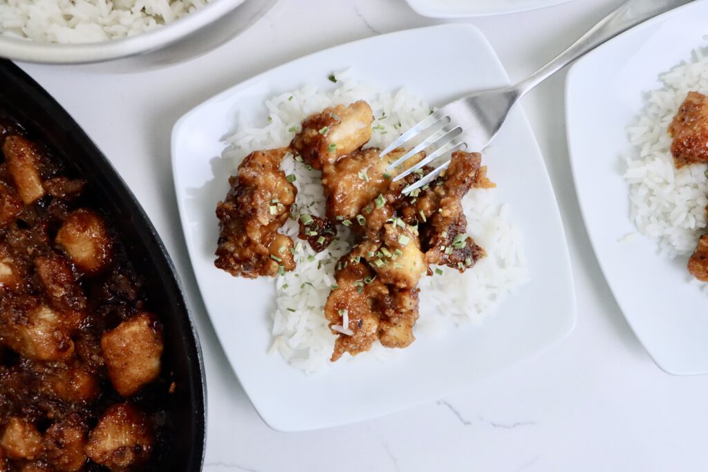 Crispy healthy orange chicken served over fluffy jasmine rice made from scratch with real ingredients