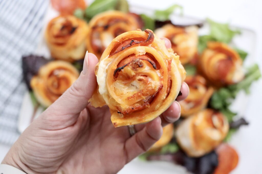 A close up of a Sourdough pepperoni pizza rolls baked until golden brown with melted cheese on top