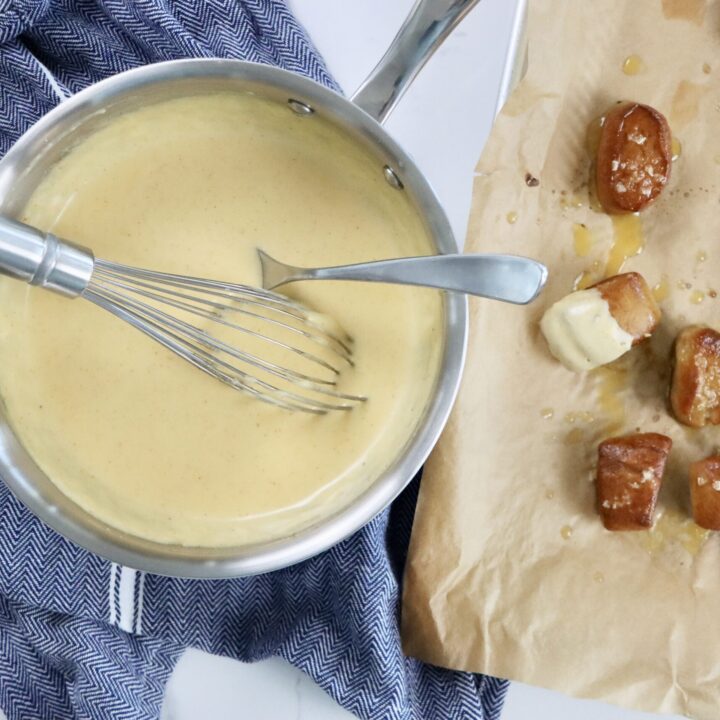Homemade cheese dipping sauce made from scratch using real ingredients, perfect for pretzels or fries.