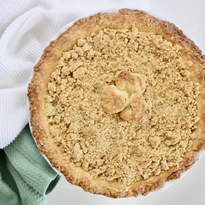 Homemade Dutch Apple Pie with golden crumb topping and thick cinnamon apple filling, fresh from the oven.