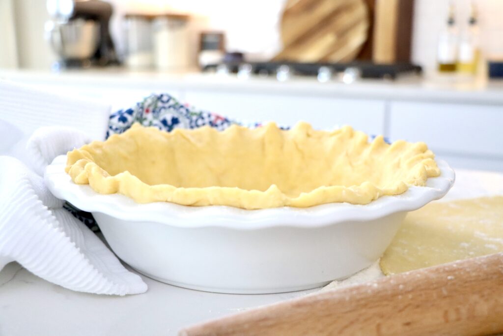 Golden flaky sourdough pie crust ready for baking, made with real butter and sourdough starter