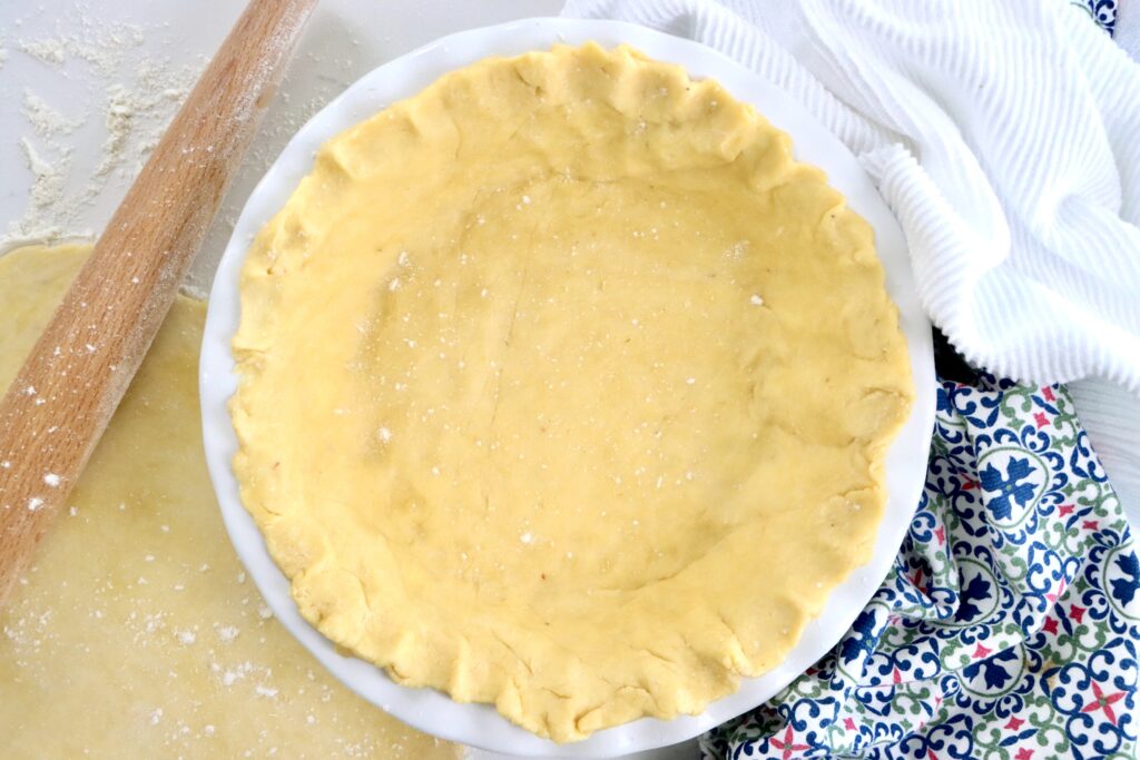 Golden flaky sourdough pie crust ready for baking, made with real butter and sourdough starter