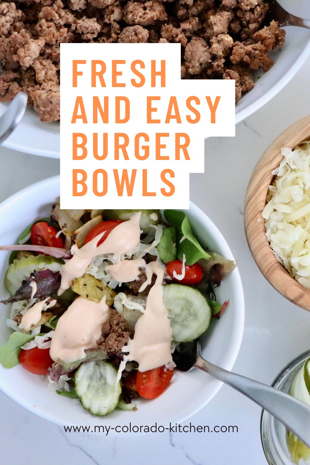 Close up of burger bowl with crispy potatoes, melted cheddar cheese, and homemade fry sauce
