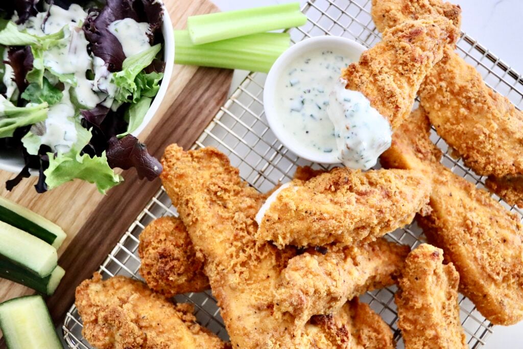 Crispy oven baked chicken tenders with a golden crunchy coating served with dipping sauce.