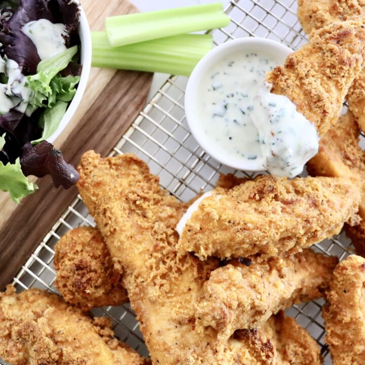 Crispy oven baked chicken tenders with a golden crunchy coating served with dipping sauce.