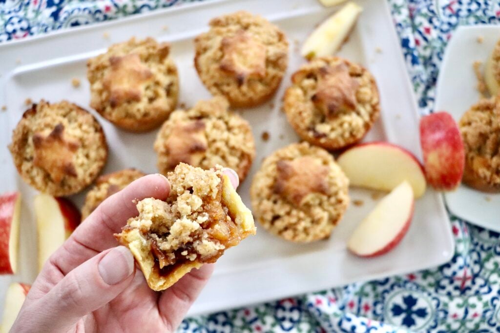 Mini Dutch Apple Pie with decorative crust shapes on top, showing soft cinnamon apple filling inside