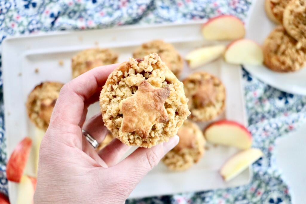 Mini Dutch Apple Pie with decorative crust shapes on top, showing soft cinnamon apple filling inside