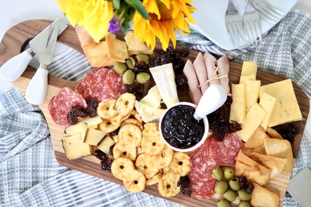 Homemade cherry jam in white dish on charcuterie board made from scratch with fresh cherries, simple small batch recipe with no pectin