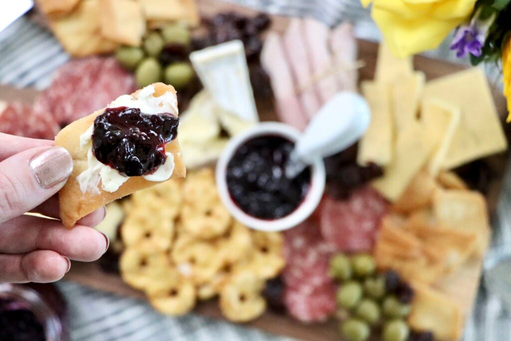 Cracker dipped in Small batch cherry jam, no pectin homemade jam made from fresh or frozen cherries