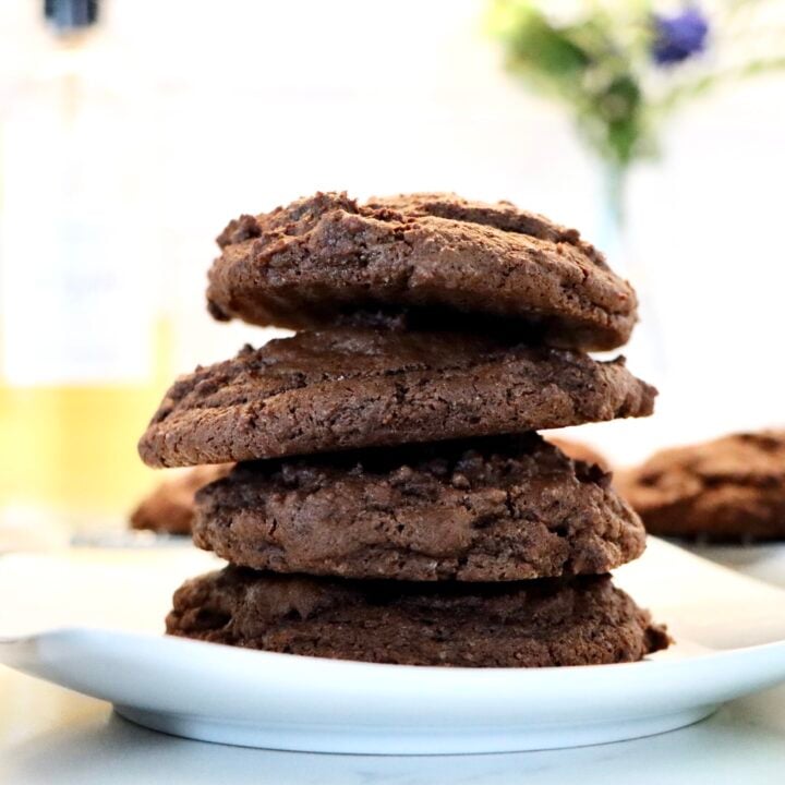 Stack of double chocolate chip cookies with melted chocolate chips and chewy centers
