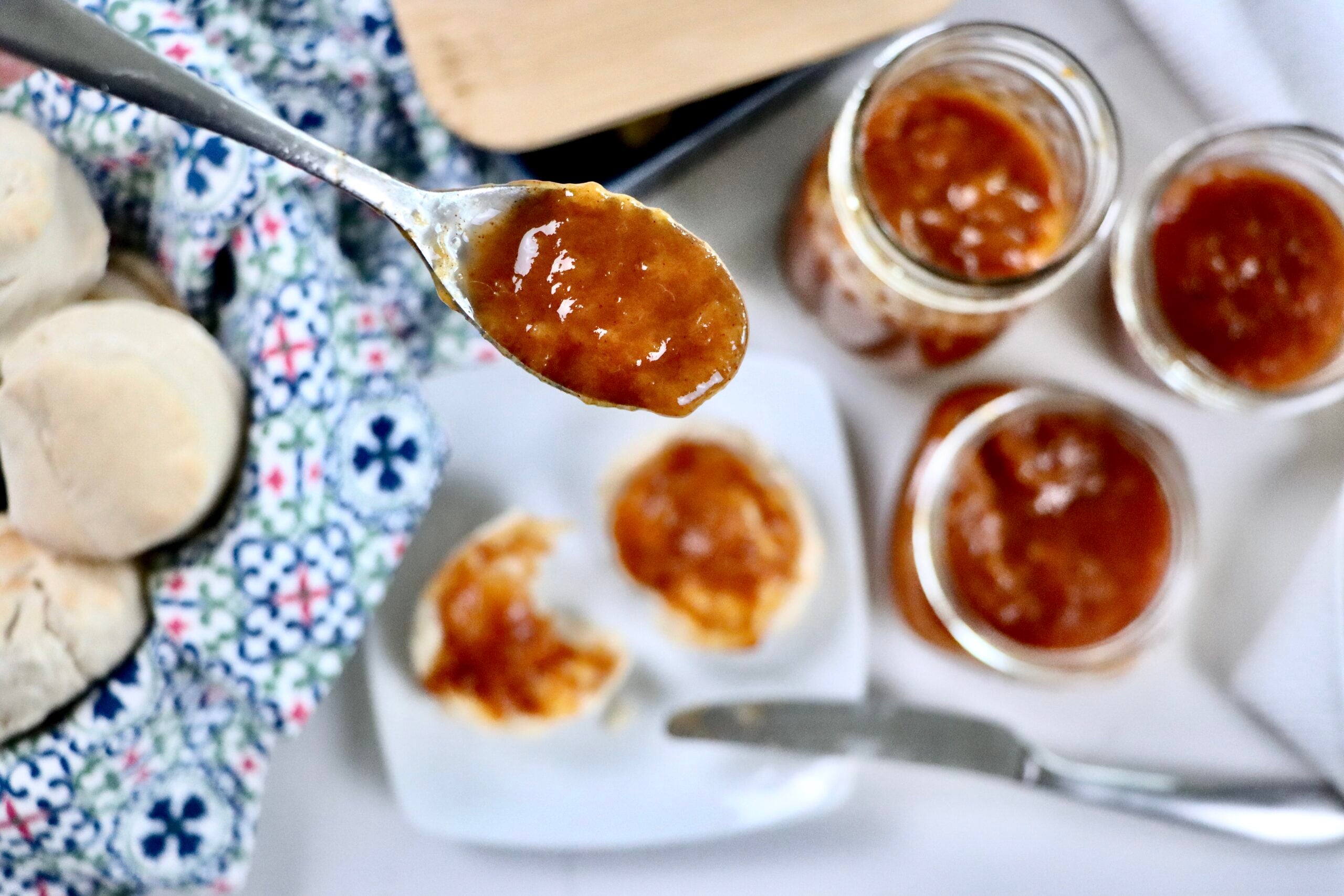 Spoonful of cinnamon peach jam showing thick texture and glossy finish