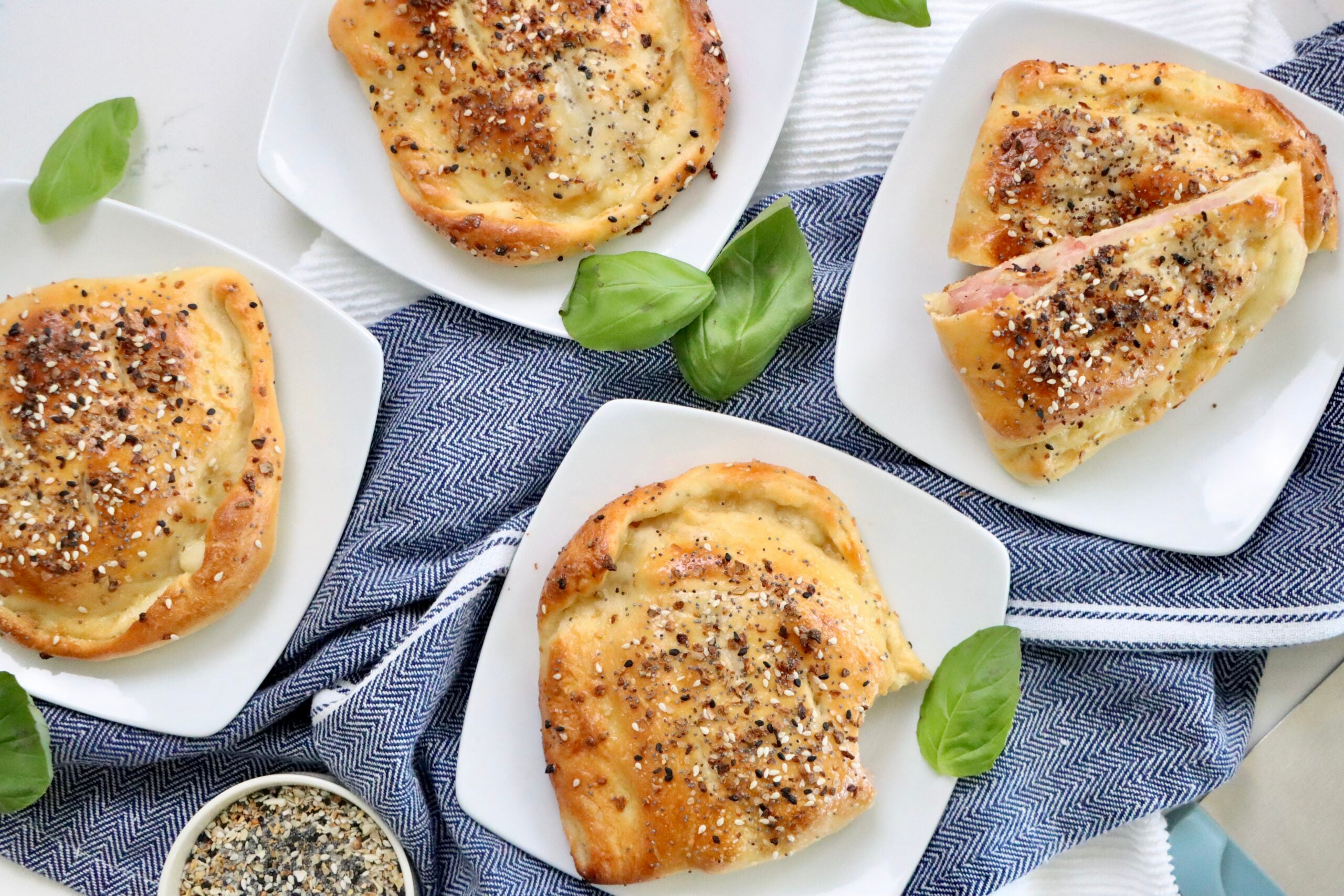 Homemade ham and cheese hot pockets made with sourdough pizza dough, baked until golden brown with a crispy exterior.