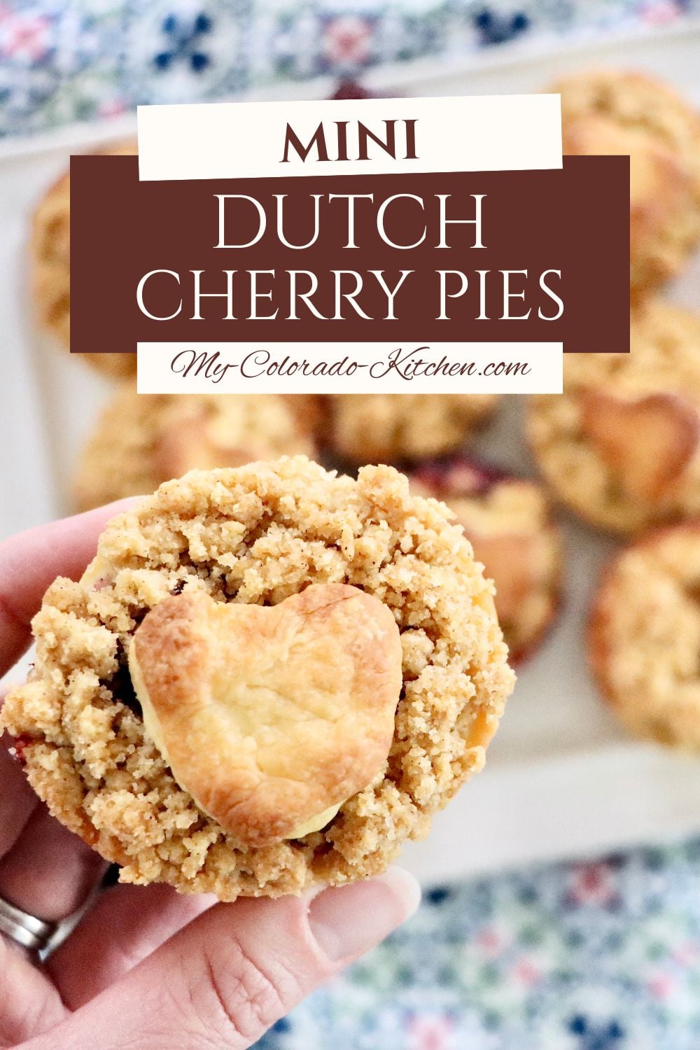 Handheld mini cherry pies with buttery streusel topping, fresh cherries bubbling inside.