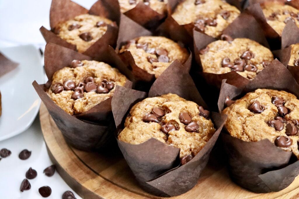 Freshly baked sourdough banana muffins with soft texture and tall muffin tops.