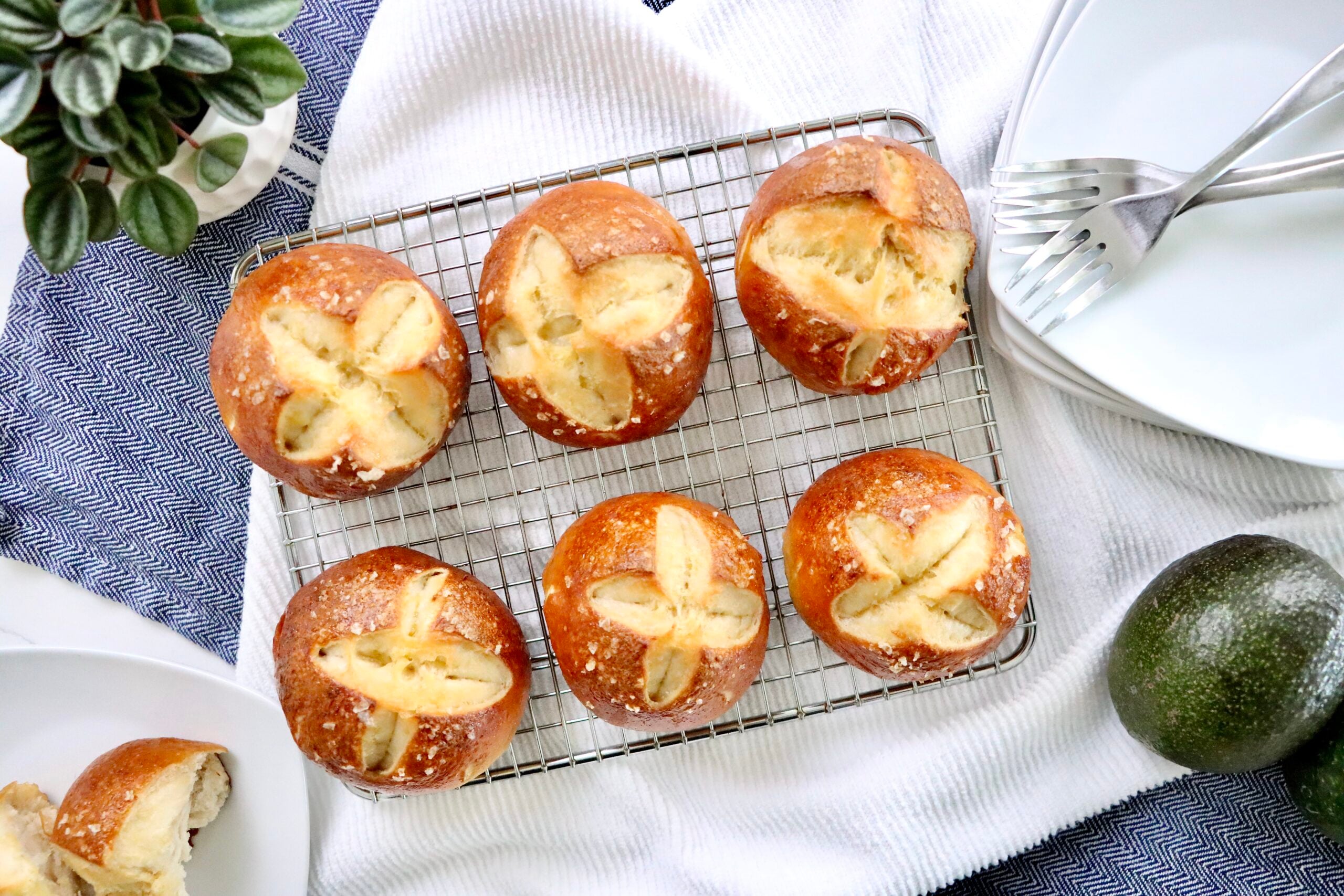Golden brown sourdough pretzel buns with classic pretzel crust and soft interior