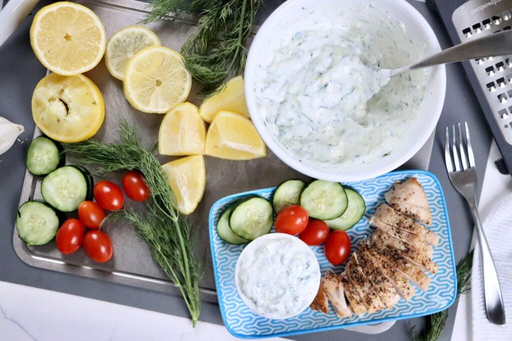 Creamy homemade tzatziki sauce made with Greek yogurt, cucumber, lemon, dill, and feta served in a bowl as a fresh healthy dip