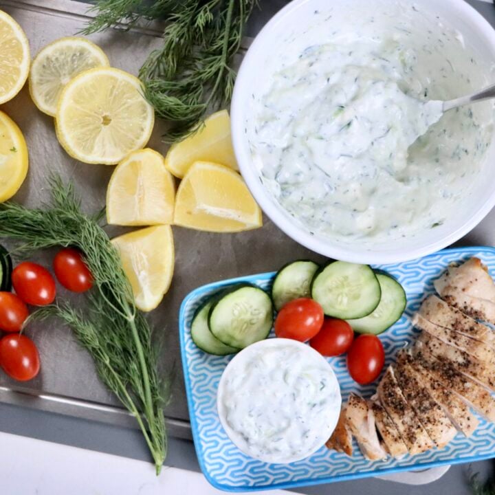 Creamy homemade tzatziki sauce made with Greek yogurt, cucumber, lemon, dill, and feta served in a bowl as a fresh healthy dip
