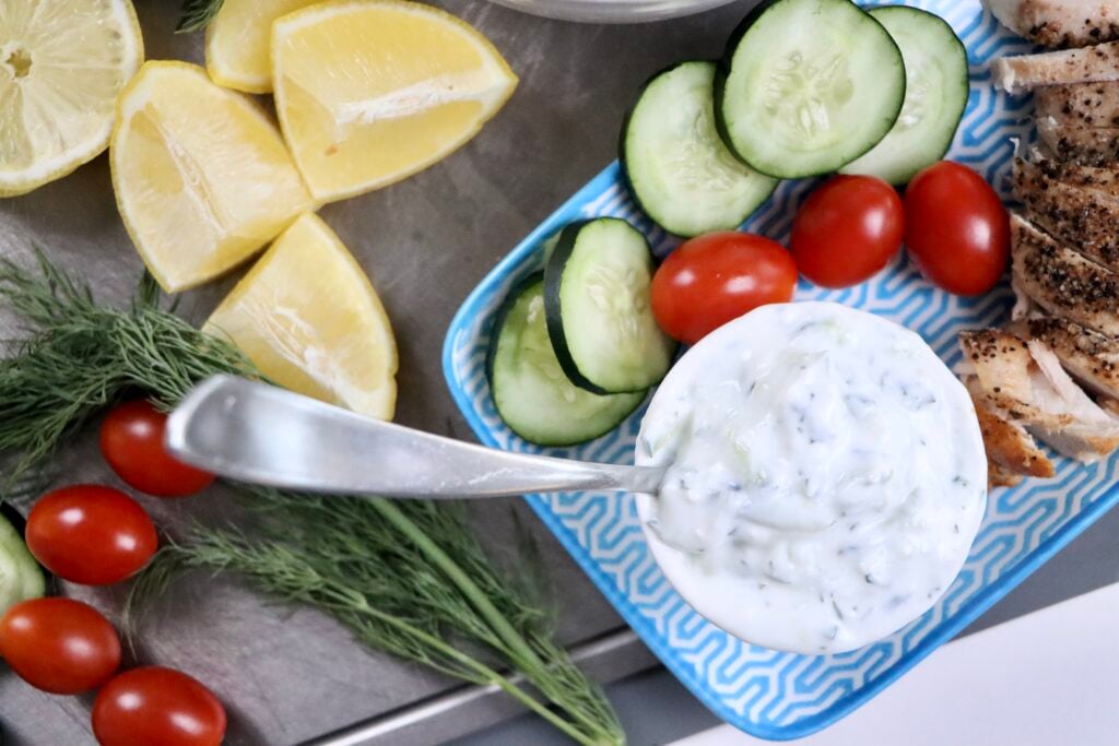 Close-up of thick and creamy tzatziki sauce showing Greek yogurt, shredded cucumber, garlic, and dill for a fresh homemade dip