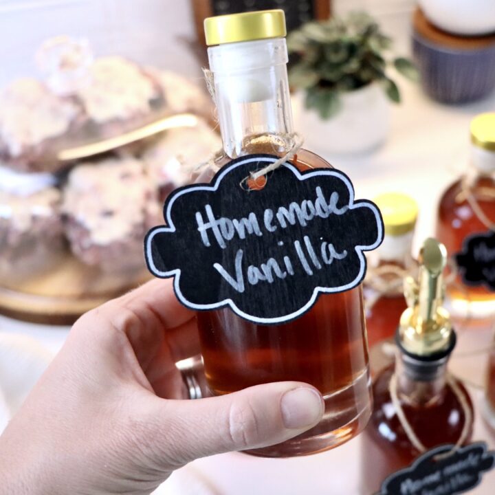 Glass bottle of homemade vanilla extract infused with vanilla beans, easy 2-ingredient recipe.